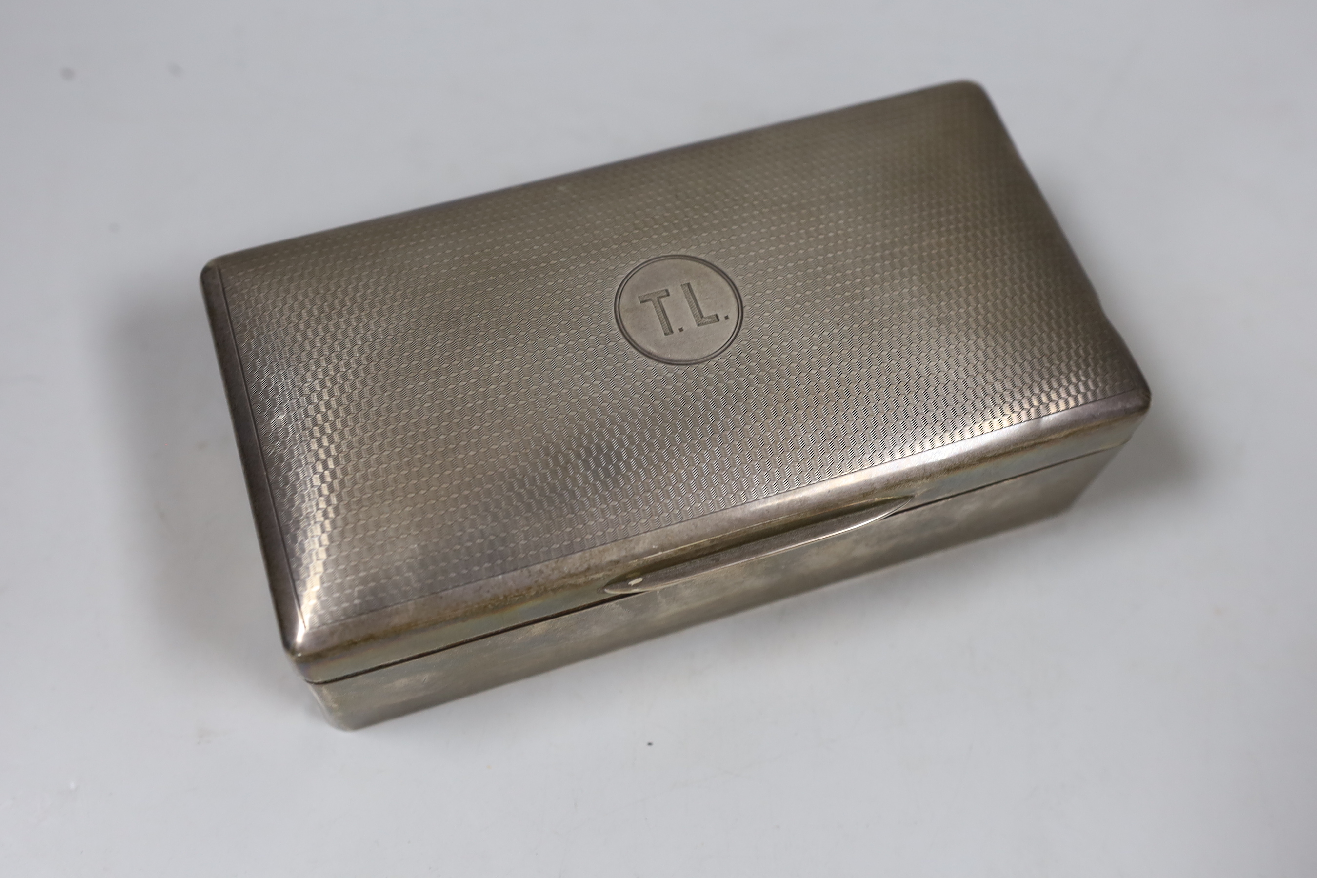 A George V part engine turned silver mounted rectangular cigarette box, London, 1918, 18cm.
